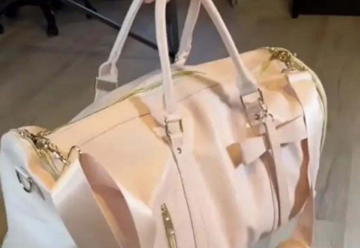 A cream Luhxe bag held up by its handles